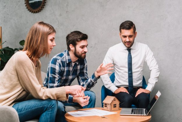 Couple talking to insurance broker